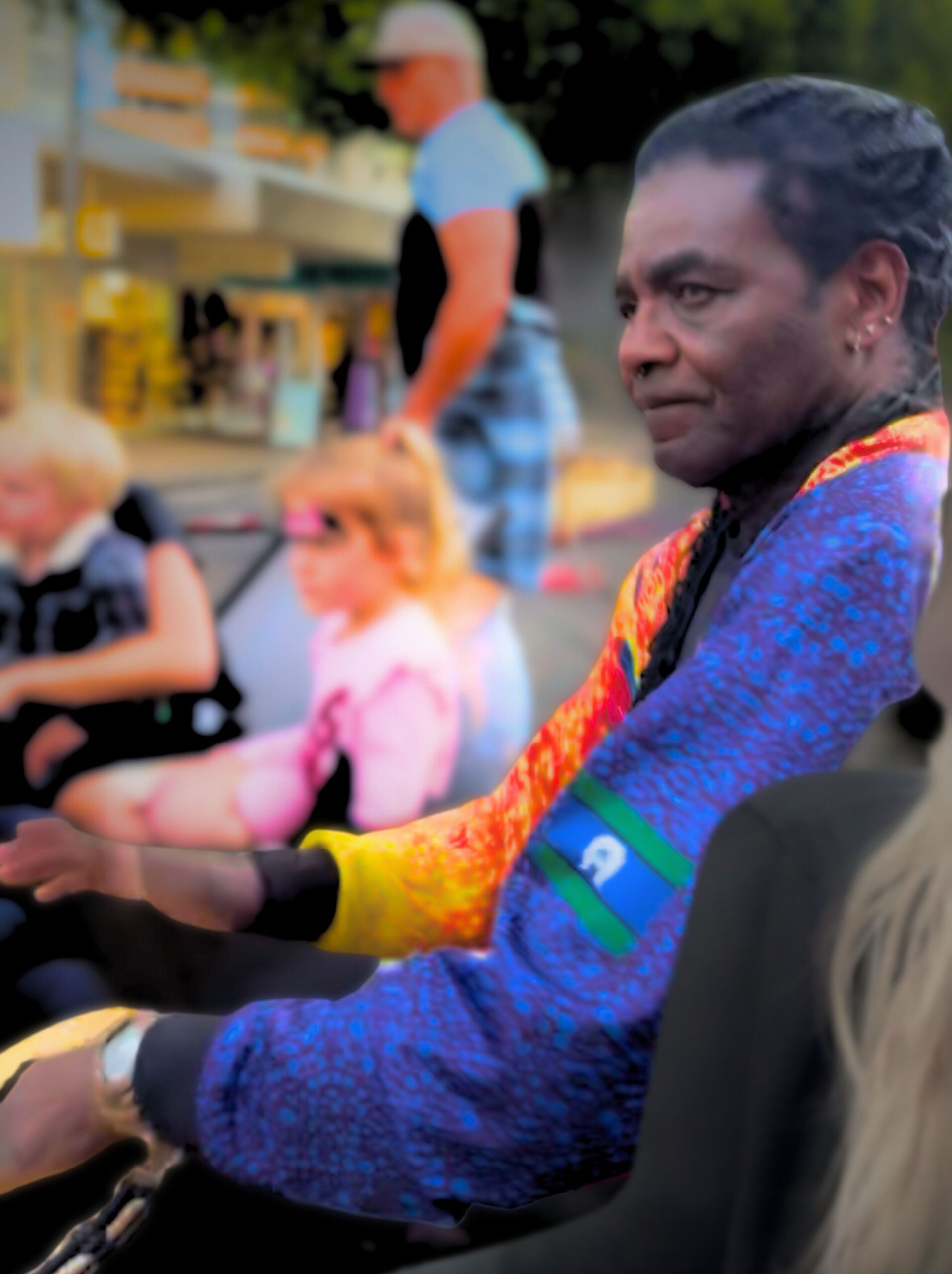 Dominique B. Cisse drumming with focused intensity, captured mid-performance. He exudes passion and rhythm, embodying his deep Afro-Caribbean and African musical roots.